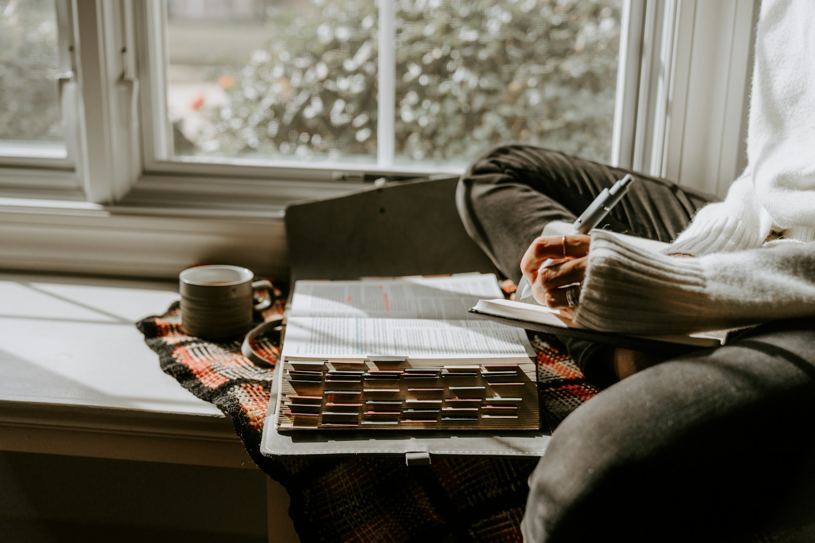 An introverted retiree enjoying a quiet moment with a book and coffee in a peaceful home setting.